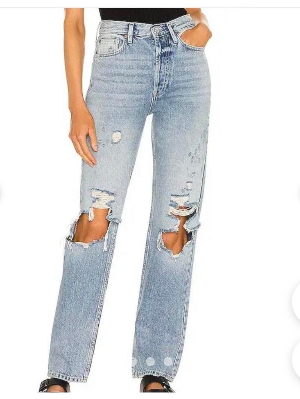 Free People distressed boyfriend jeans in a light wash with ripped detailing.